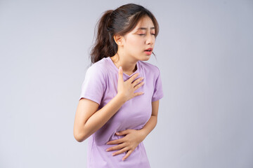 Young Asian woman suffering from gastroesophageal reflux disease