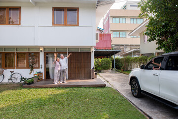 Happy Asian multi-generation family spending time together at home. Parents with cute baby child girl driving car to visit grandparents at home. Family relax and having fun weekend vacation together