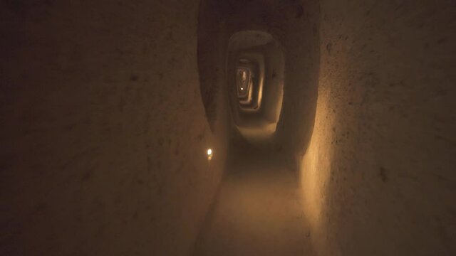 A long corridor connecting the rooms of the underground city.Subterranean defensive refuge place living cellar storage cellars cisterns drainage channel narrow road inside cave excavated old stone age