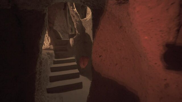 A long corridor connecting the rooms of the underground city.Subterranean defensive refuge place living cellar storage cellars cisterns drainage channel narrow road inside cave excavated old stone age