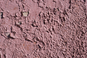 Old, cracked burgundy paint on the wall. Textured surface, background