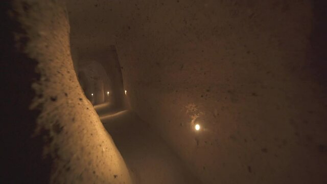 A long corridor connecting the rooms of the underground city.Subterranean defensive refuge place living cellar storage cellars cisterns drainage channel narrow road inside cave excavated old stone age