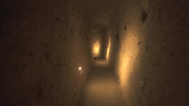 A long corridor connecting the rooms of the underground city.Subterranean defensive refuge place living cellar storage cellars cisterns drainage channel narrow road inside cave excavated old stone age