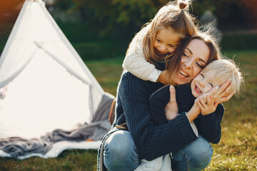 Mother with children playing in a summer park © prostooleh