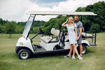 Beautiful couple playing golf on a golf course