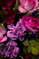 Obraz premium Bouquet of pink English roses, tulip, carnation and green close up vertical