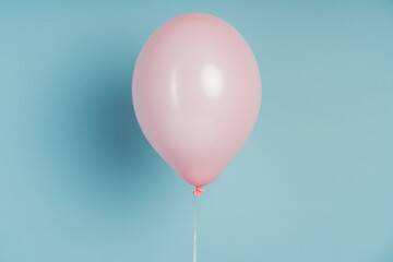 Fototapeta na wymiar Pink ball on pastel blue tones.The minimum concept.