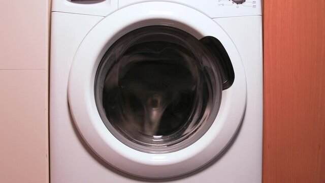 Washing machine working at high speed: front view 4k slow motion