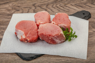 Raw pork medallion served rosemary