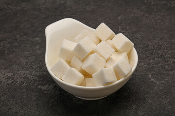 Refined white sugar cubs in the bowl