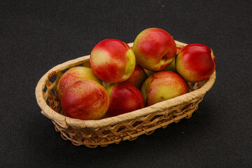 Sweet small nectarines in the basket