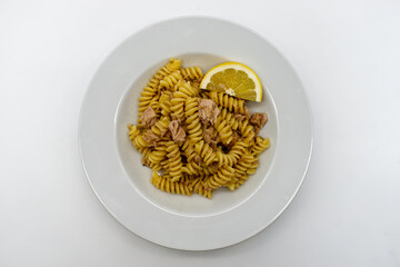 Italian Fusilli Pasta with tuna and lemon in a white dish