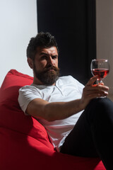 Celebrate alone. Hipster with alcohol. Bearded man with wine. Home alone party.