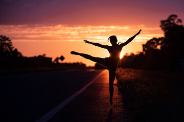 Young woman dancing in summer sunset sky outdoor. People freedom.