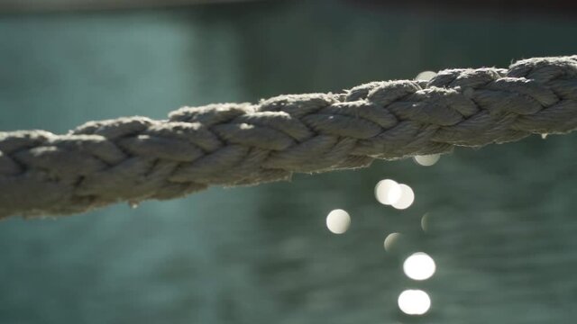 Close up shot of a dock line with the sparkling ocean in the background