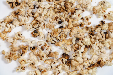 spoiled burnt grains of popcorn close-up.