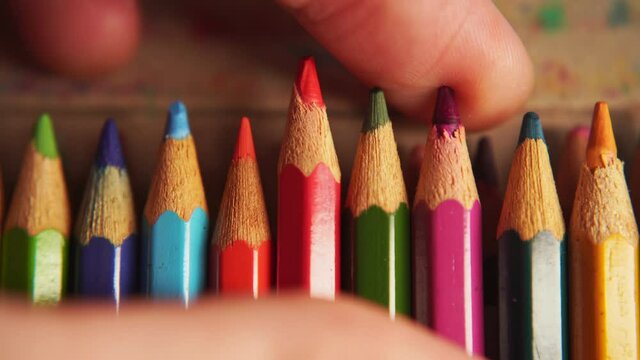 picking a colored pencil from a box