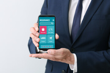 Man with open page of insurance company site on screen of mobile phone. Real estate insurance online