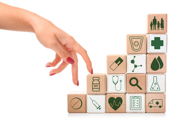 Stacked cubes and female hand on white background. Health care insurance concept