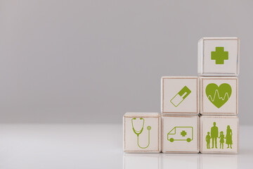 Wooden cubes on grey background. Health care insurance concept
