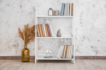 Shelf unit with stack of books in room