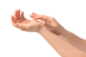 Young woman applying cream on her hands against white background