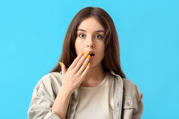 Young woman with beautiful manicure on color background