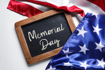 Fototapeta na wymiar Chalkboard with text MEMORIAL DAY and USA flag on light background