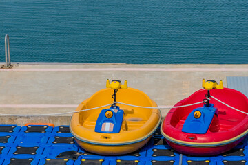 Small electric boats for children at marina.