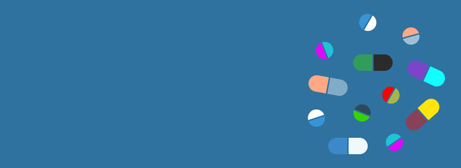 Colorful medical pills on blue background.
