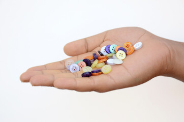 the colorful button holding hand isolated on white background.