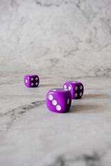 rolling dice on the white marble table surface