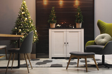 Beautiful room interior with decorated Christmas tree and modern furniture