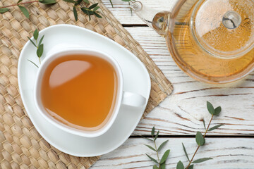 Aromatic eucalyptus tea on white wooden table, flat lay