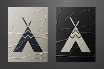 White Traditional indian teepee or wigwam icon isolated on crumpled paper background. Indian tent. Paper art style. Vector © Vadim