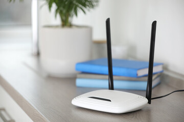 Modern Wi-Fi router indoors. Space for text