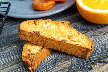 Biscotti with orange filling on a dark table
