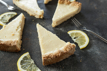 appetizing lemon pie on a dark background, lemon cheesecake