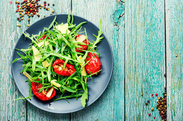 Healthy salad with dried tomato and arugula,copy space