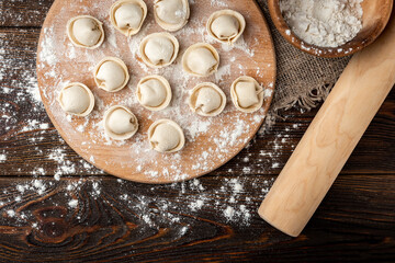 Preparation dumplings on wooden board.