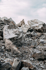 Mining process. Rocks for mining. Big gray limestone.