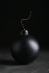 Naklejka na ściany i meble Sphere shaped bomb with burning fuse on black background