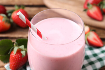 Delicious drink with strawberries in glass on table, closeup