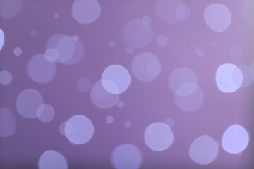 Fototapeta na wymiar Blurred view of festive lights on violet background. Bokeh effect