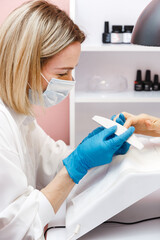 Woman on manicure treatment in beauty salon. Manicure, beauty procedures and personal care. Portrait