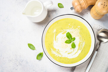 Zucchini soup with spinach and herbs at white.