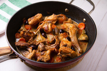 Wild rabbit cocked with artichokes and black olives. Traditional tapa from south spain.