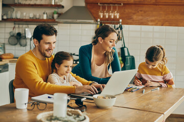 Happy dedicated parents enjoying the time they are spending with their daughters at home.