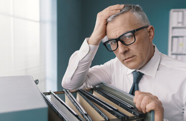 Businessman searching for files in the office