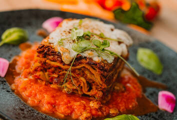 Italian lasagne home made lasagna, lazania z miesem, domowa lazania, lasagne, Italian Beef Lasagna Lasagne with bolognese meat sauce, bechamel, cheese and basil on white board. lazzania domowej roboty © Silesia